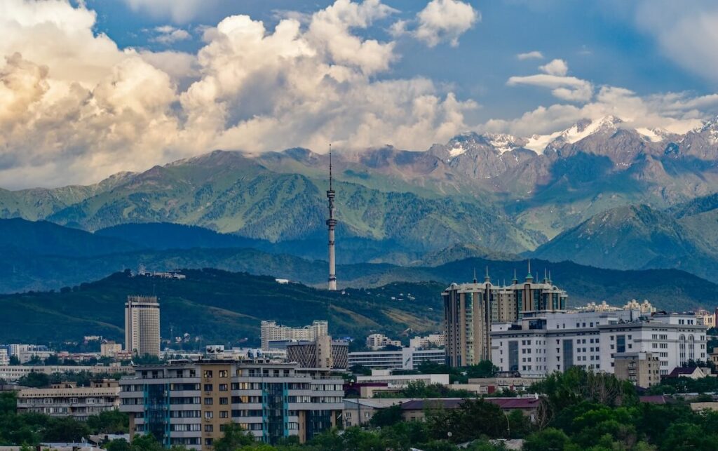 panoramic view of Almaty cityscape with mountains in the background