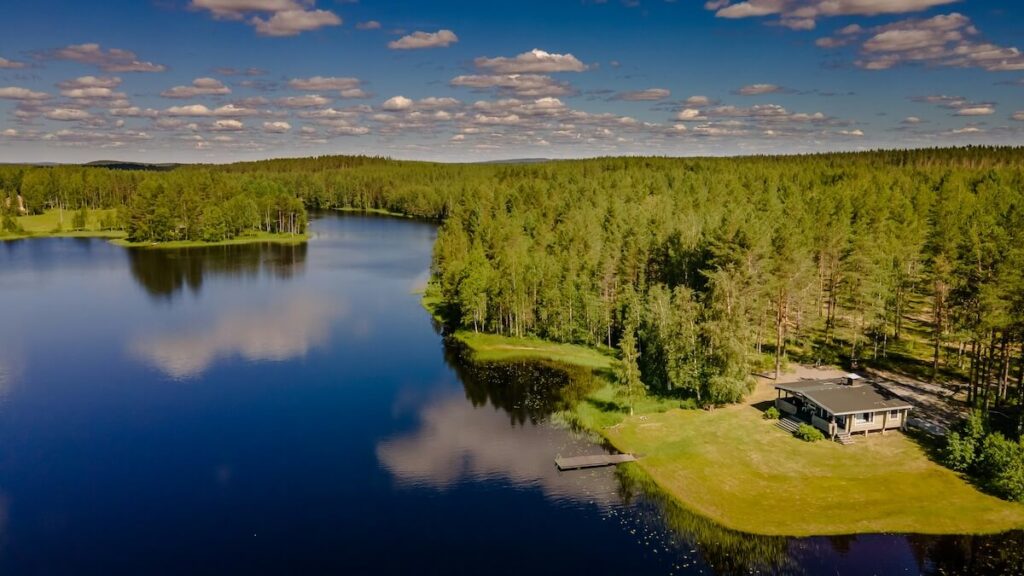 The serene panoramic view of a summer cottage and lake in Lieksa, Finland