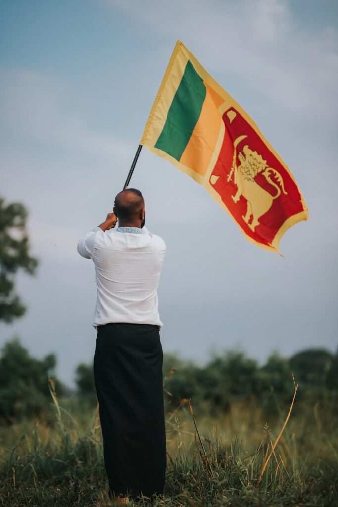 man waving Sri Lankan flag
