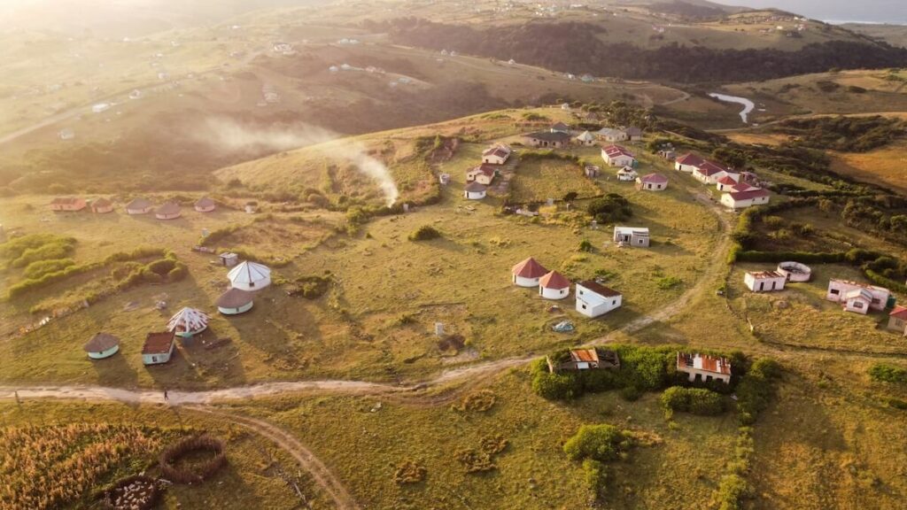 Sunrise and smoke from the breakfast fire hang over a rural amaXhosa village in the Eastern Cape in South Africa