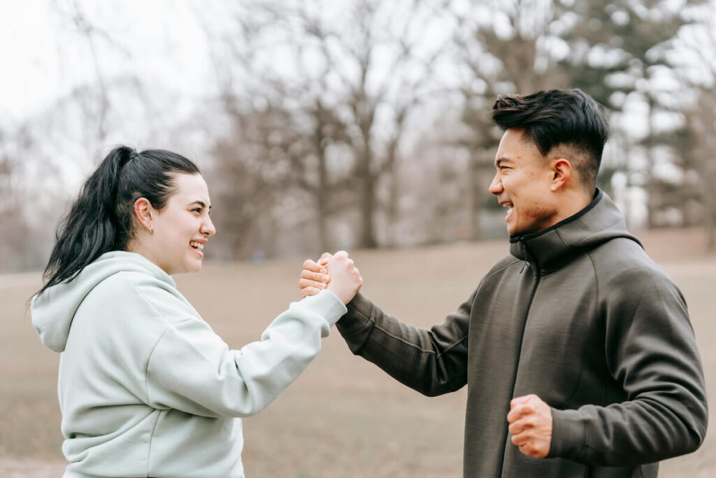 man and woman holding hands to show support
