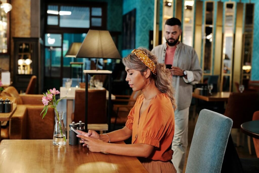 woman holding phone, waiting for date