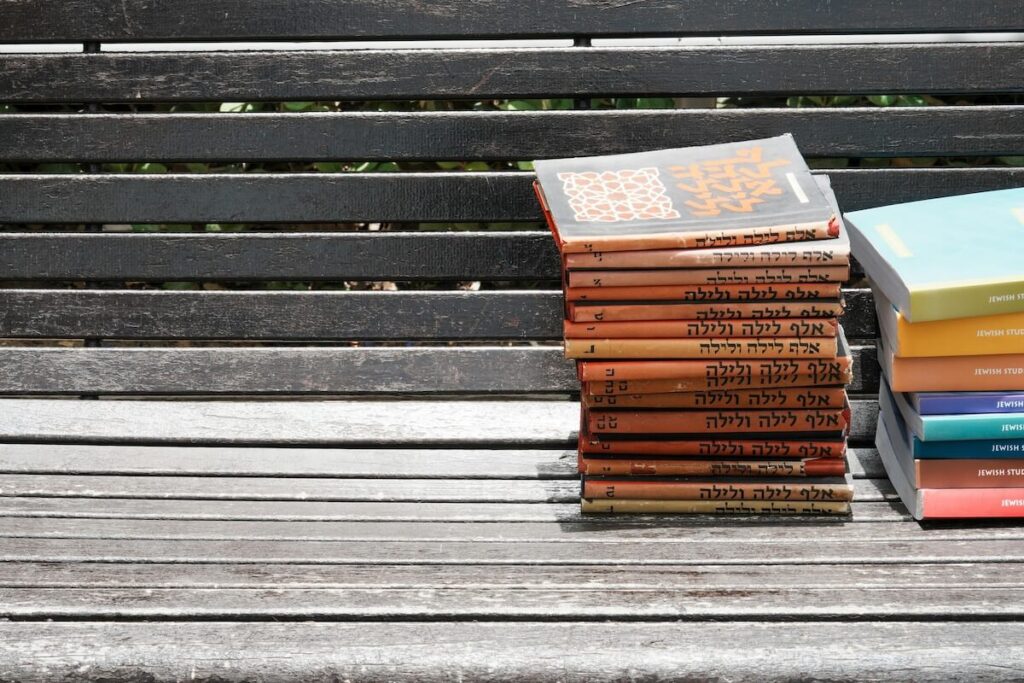 pile of Hebrew books on bench
