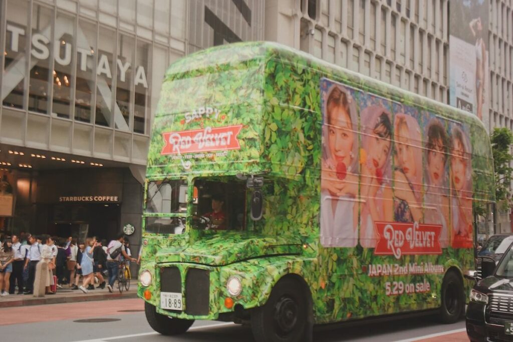 green bus in Japanwith wraparound of Red Velvet