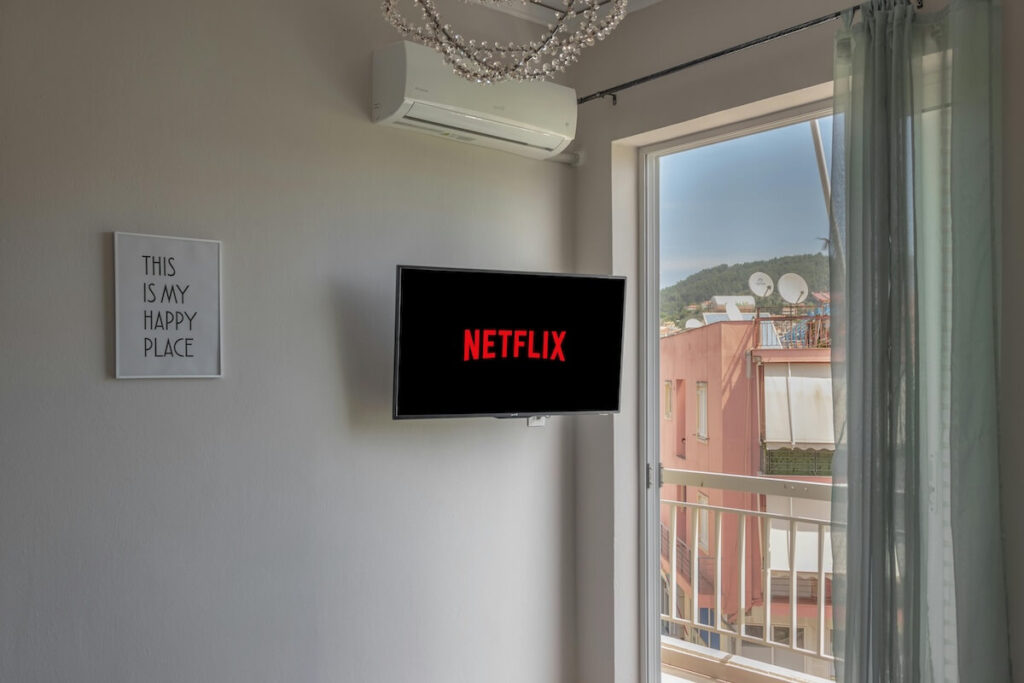 TV mounted on wall, showing Netflix logo