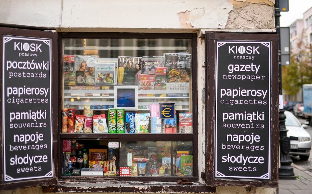 newspaper stand with Polish and English signs