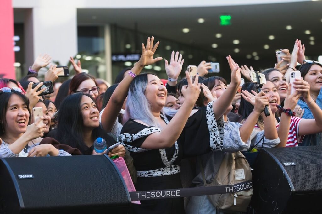happy K-pop fans in a concert