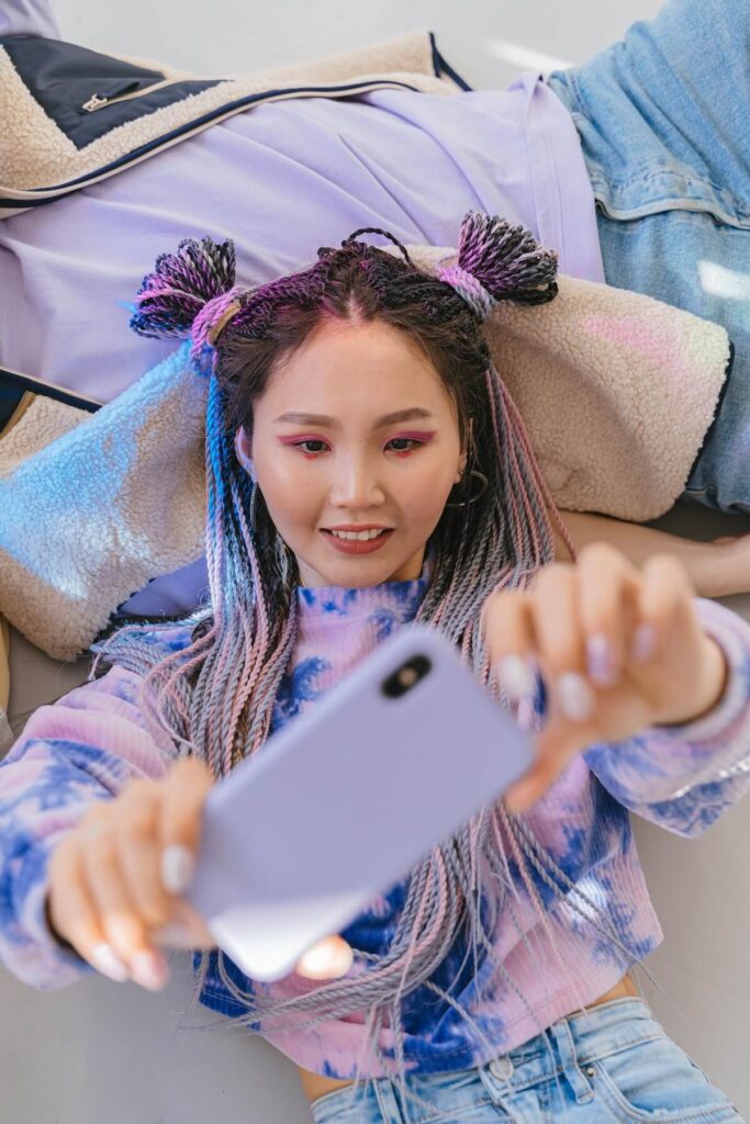 woman in colorful clothes and style, taking a selfie