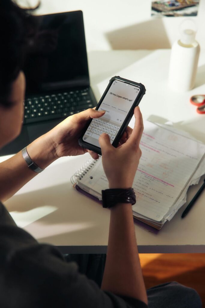 man using phone to study