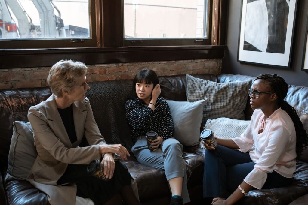 diverse women conversing in workplace