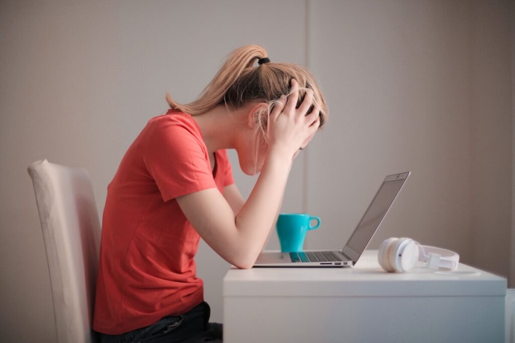 frustrated student in front of laptop