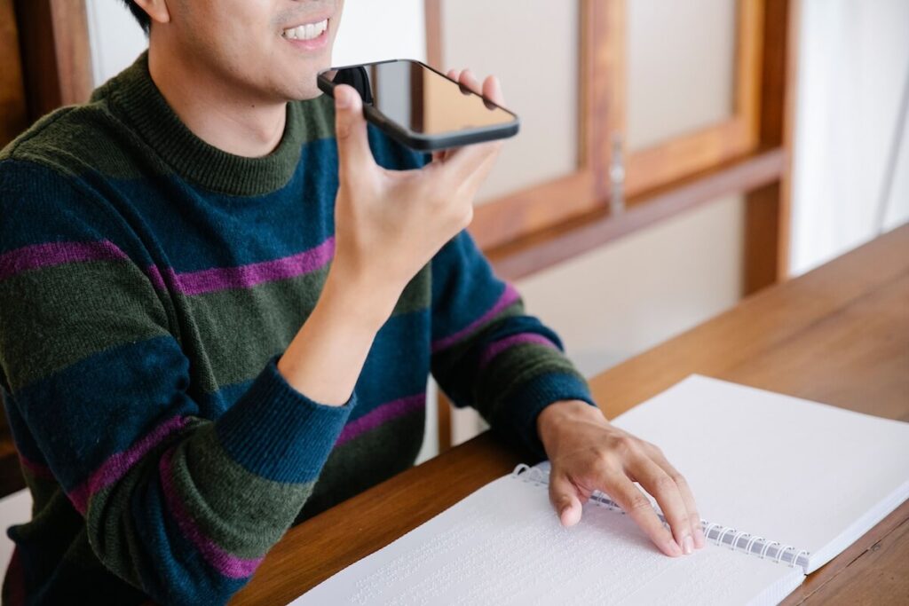man recording his voice on phone