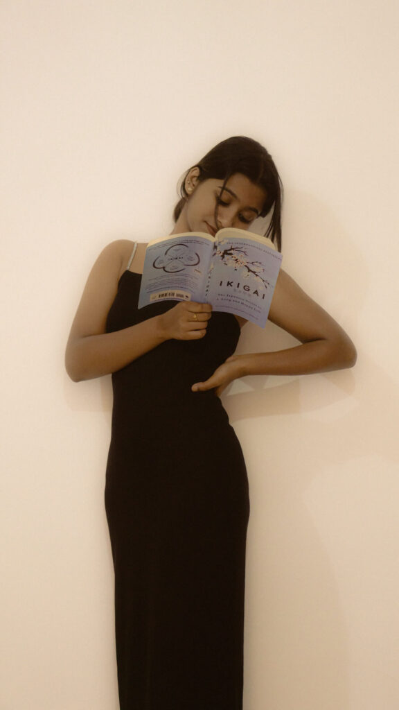 woman posing whiel reading Ikigai book